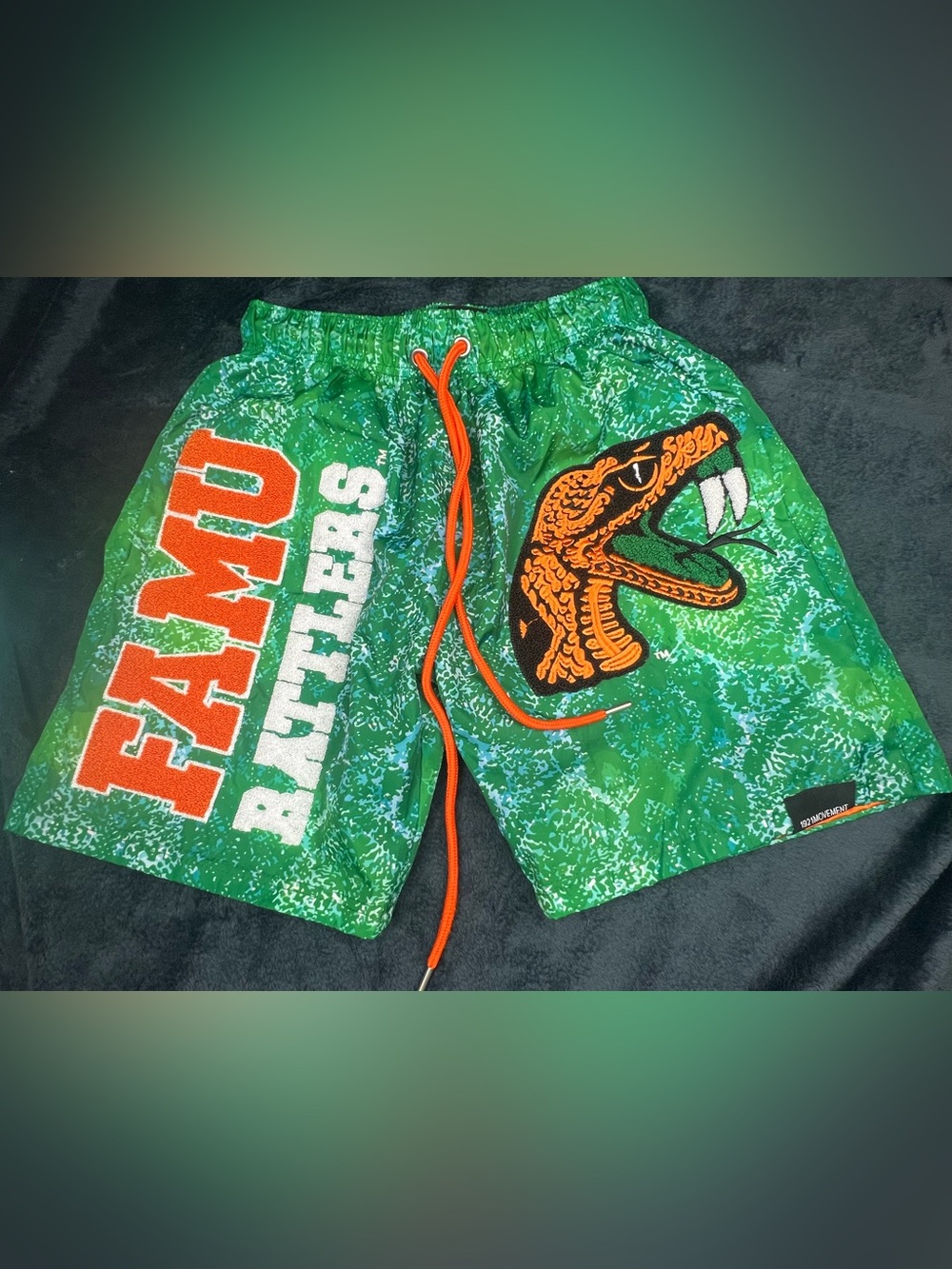 Green Rattler Print Men’s Swim Trunks with Orange Accents
